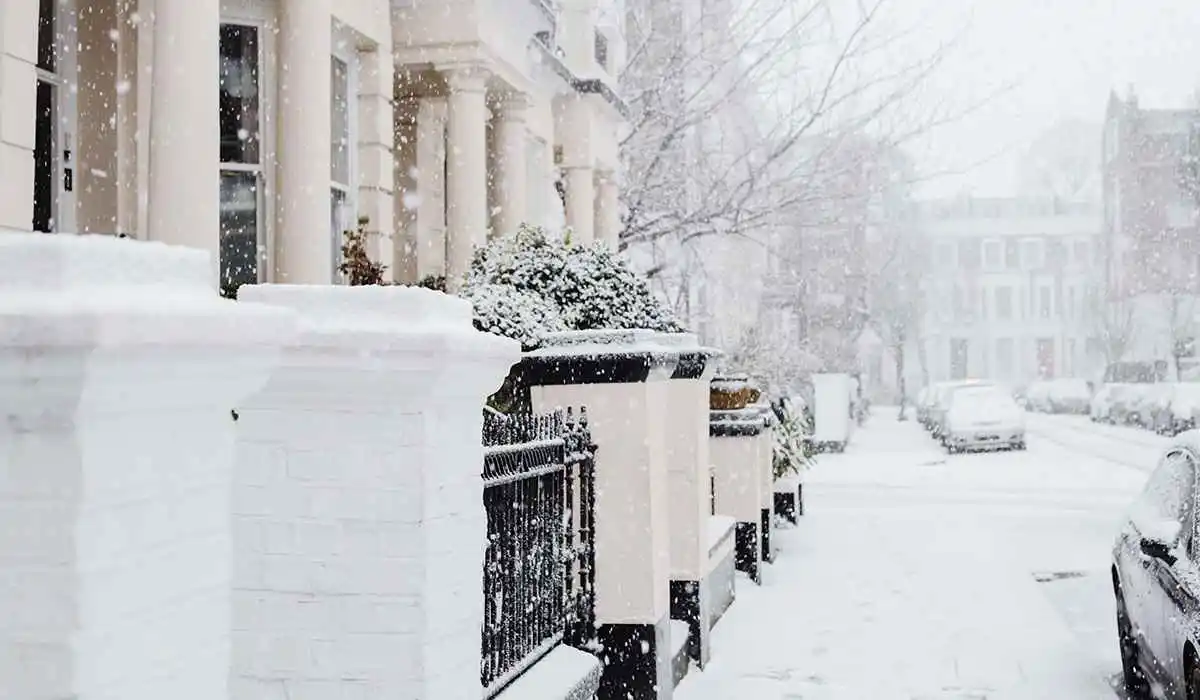 Street with individual houses covered in snow