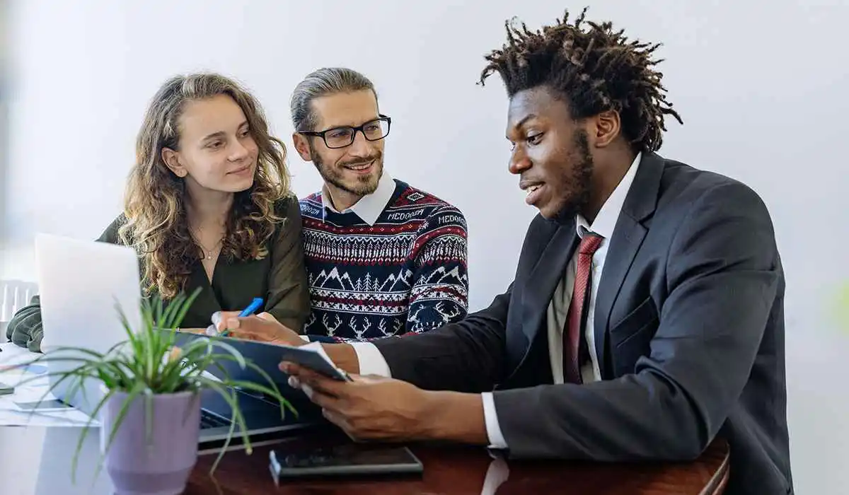 A financial advisor explaining to a young couple  
