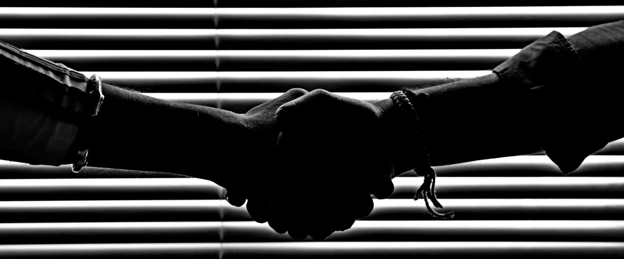 A Robot hand shaking a human hand