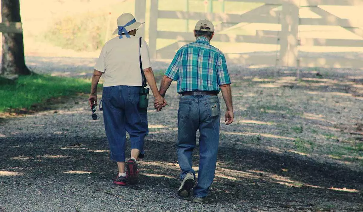 An old couple walking and holding hands