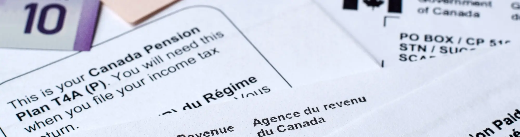 Close-up of a single water droplet suspended above a ripple on a calm blue water surface against a dark background.